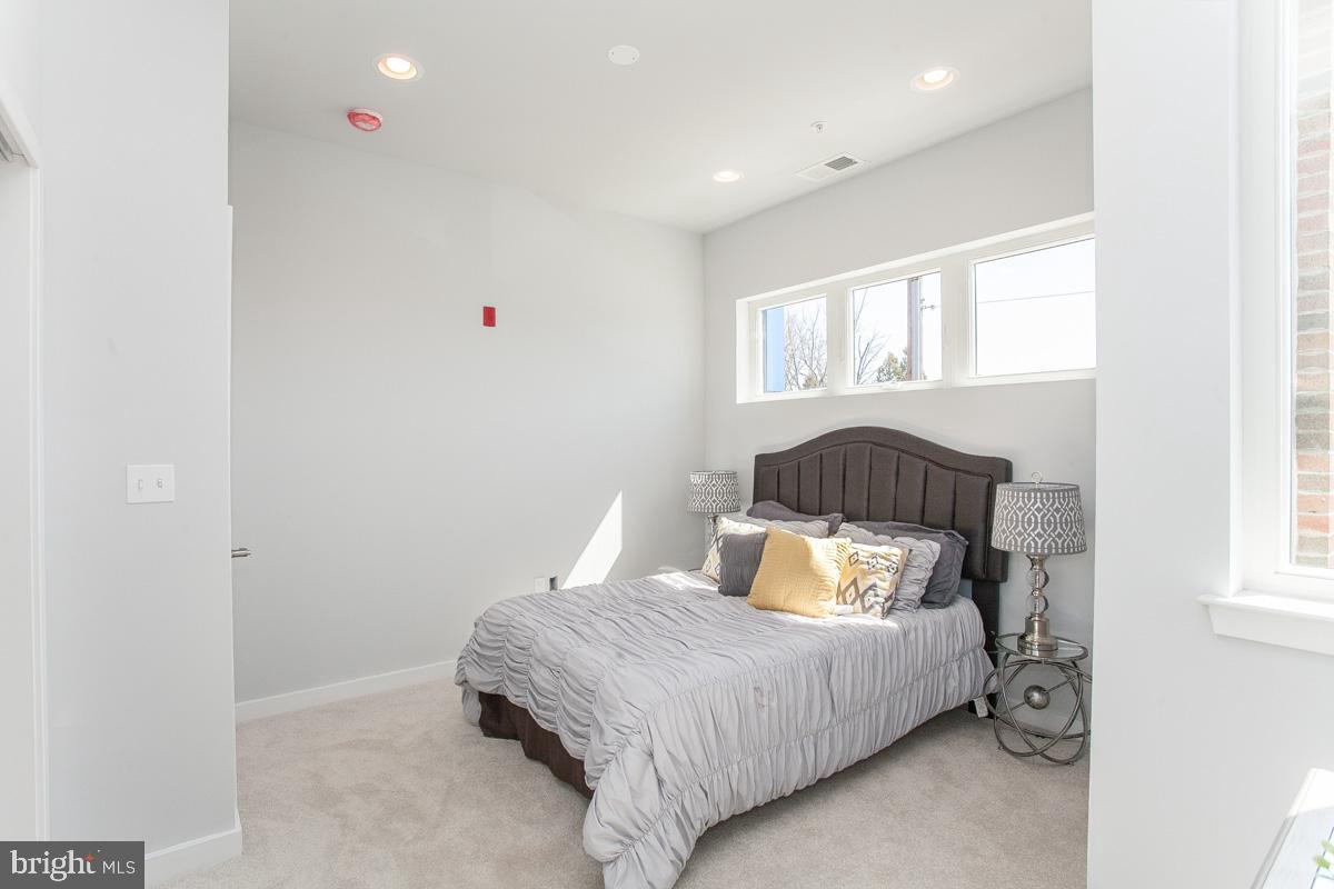 5938 Henry Avenue, Unit 21 Philadelphia, PA 19128 - Photo 13 of 19 a bedroom with a bed and a window