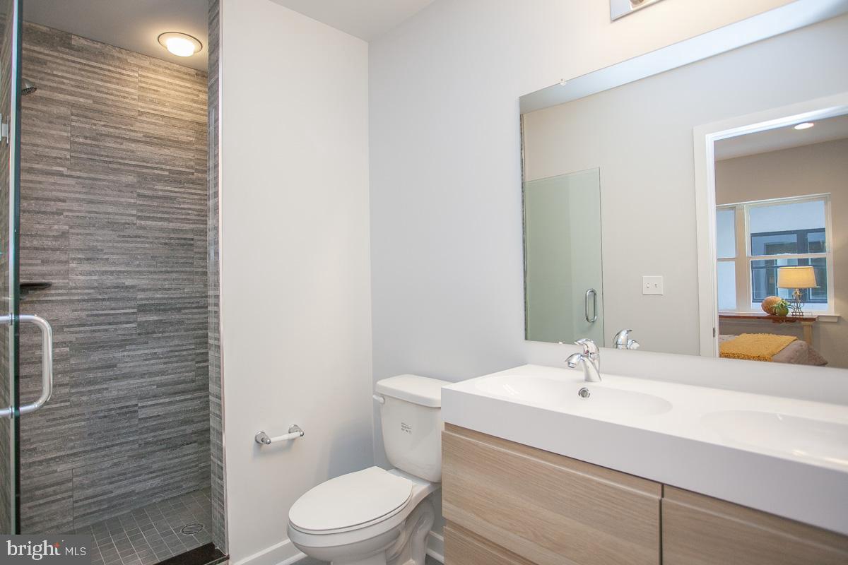 5938 Henry Avenue, Unit 21 Philadelphia, PA 19128 - Photo 18 of 19 a bathroom with a sink a toilet and shower