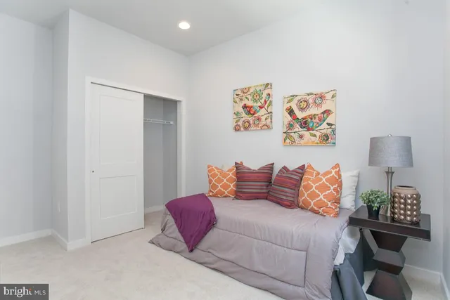 a bedroom with furniture and a lamp