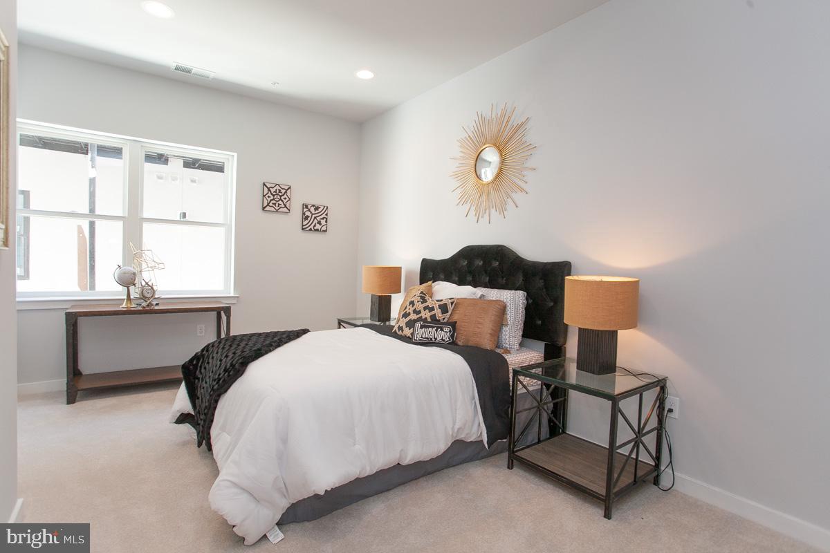 5938 Henry Avenue, Unit 21 Philadelphia, PA 19128 - Photo 10 of 19 a bedroom with a bed and a window