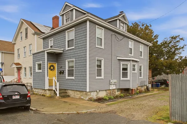 a view of a car park in front of a house