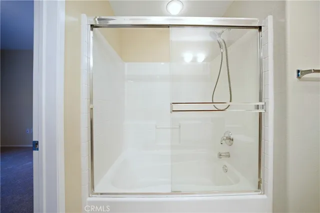 a bathroom that has a glass shower door