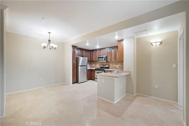a kitchen with refrigerator and cabinets