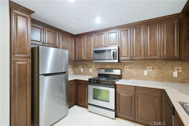 a kitchen with a refrigerator stove and microwave