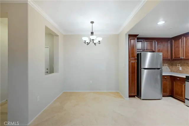 a view of a kitchen with refrigerator and a sink