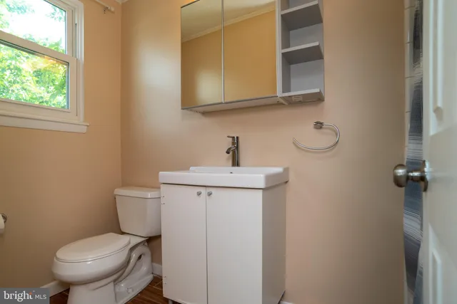 a bathroom with a toilet sink and mirror