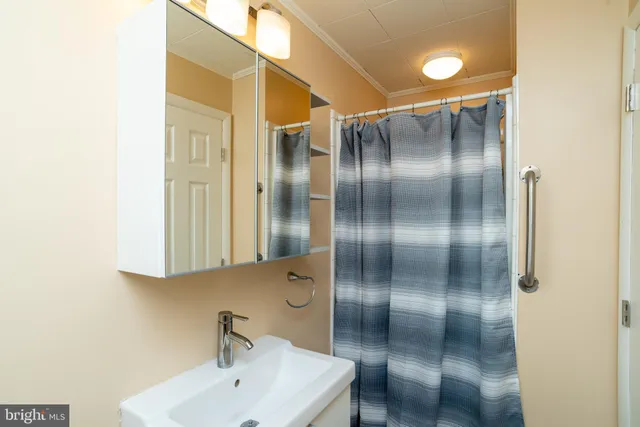 a bathroom with a mirror and a shower