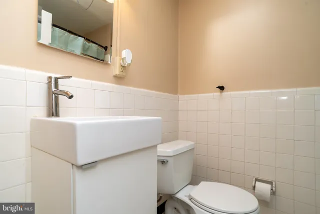 a white toilet sitting next to a white sink
