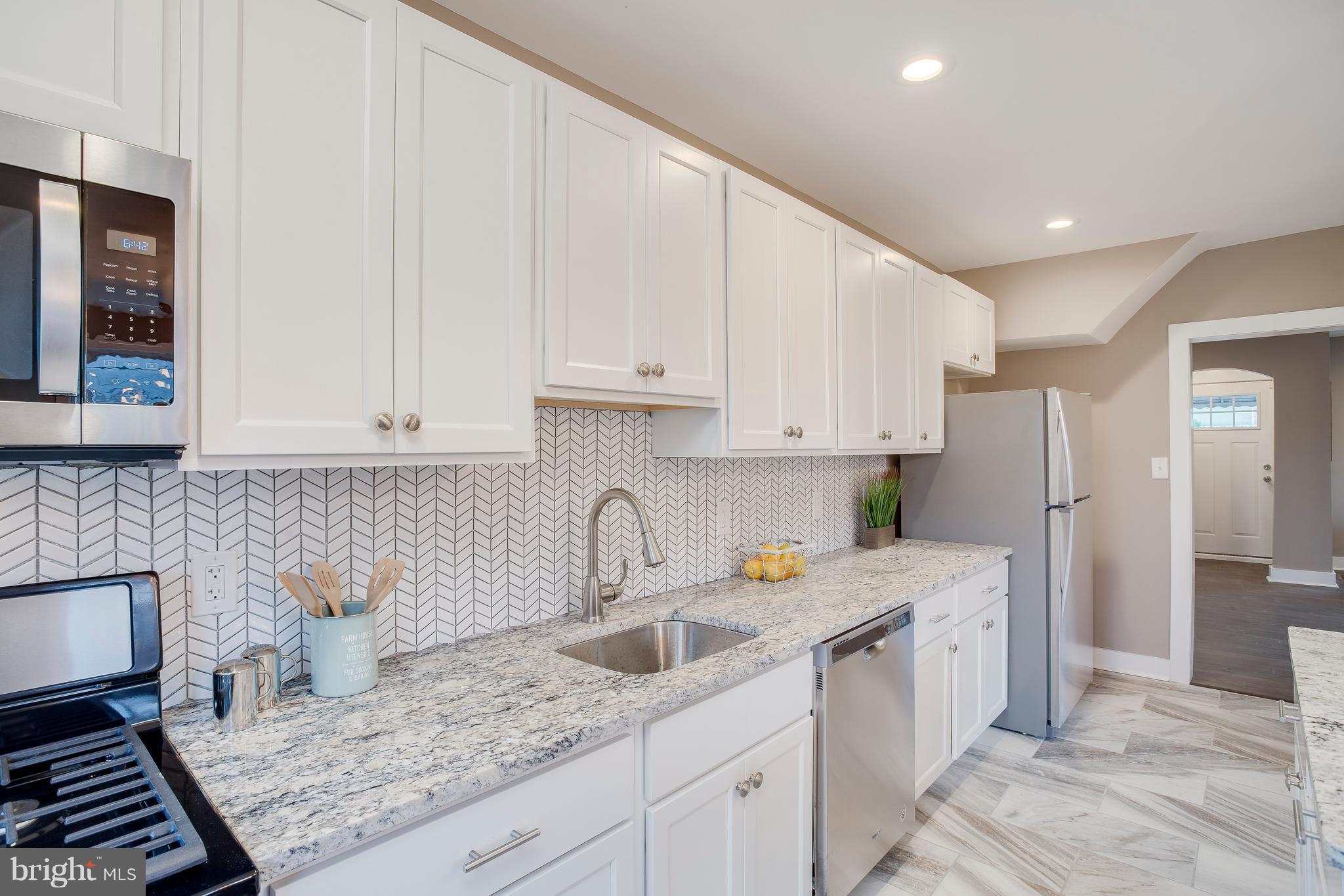 1500 Sheffield Road Baltimore, MD 21218 - Photo 14 of 30 a kitchen with a sink and cabinets