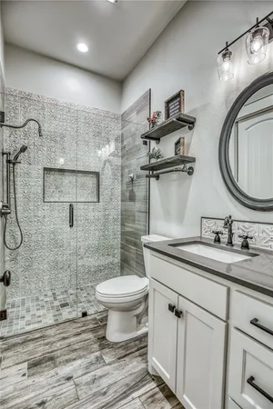 a bathroom with a sink toilet and shower
