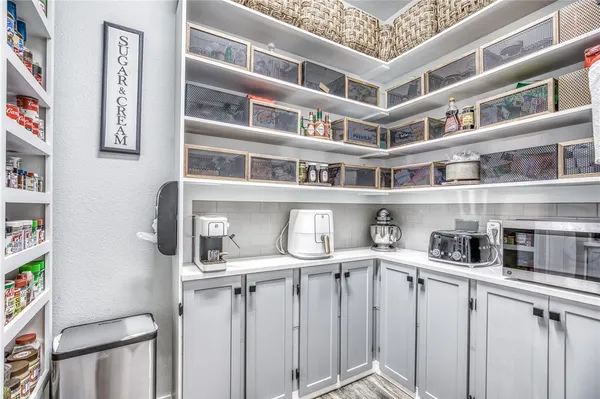 a kitchen with appliances cabinets and a window