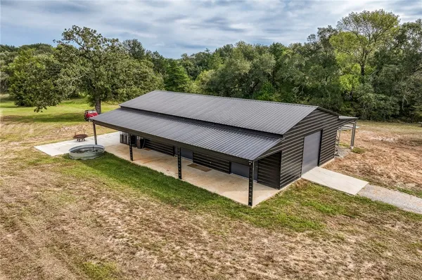 a backyard of a house with yard and trampoline