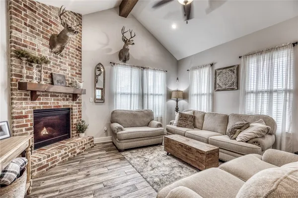 a living room with furniture a rug and a fireplace