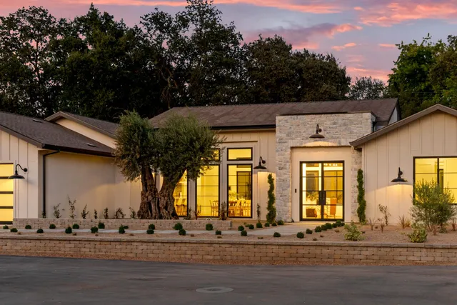 a front view of a house with a garden