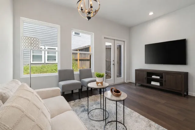 a living room with furniture a flat screen tv and a fireplace