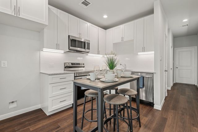 a kitchen that has a table and chairs in it