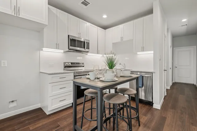 a kitchen that has a table and chairs in it