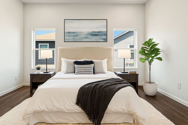 a bedroom with a bed and a painting on the wall