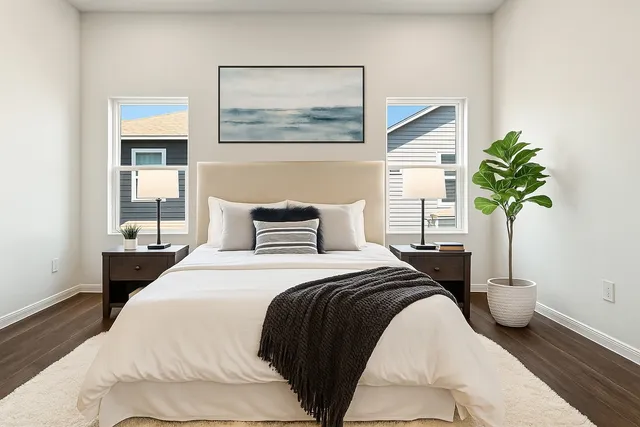 a bedroom with a bed and a painting on the wall