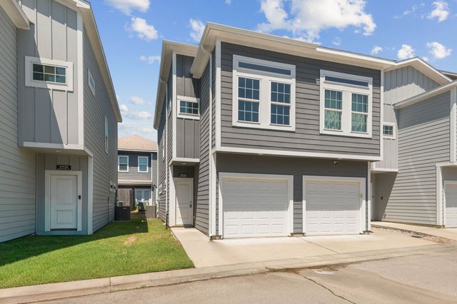 a view of a house with a garden and stairs