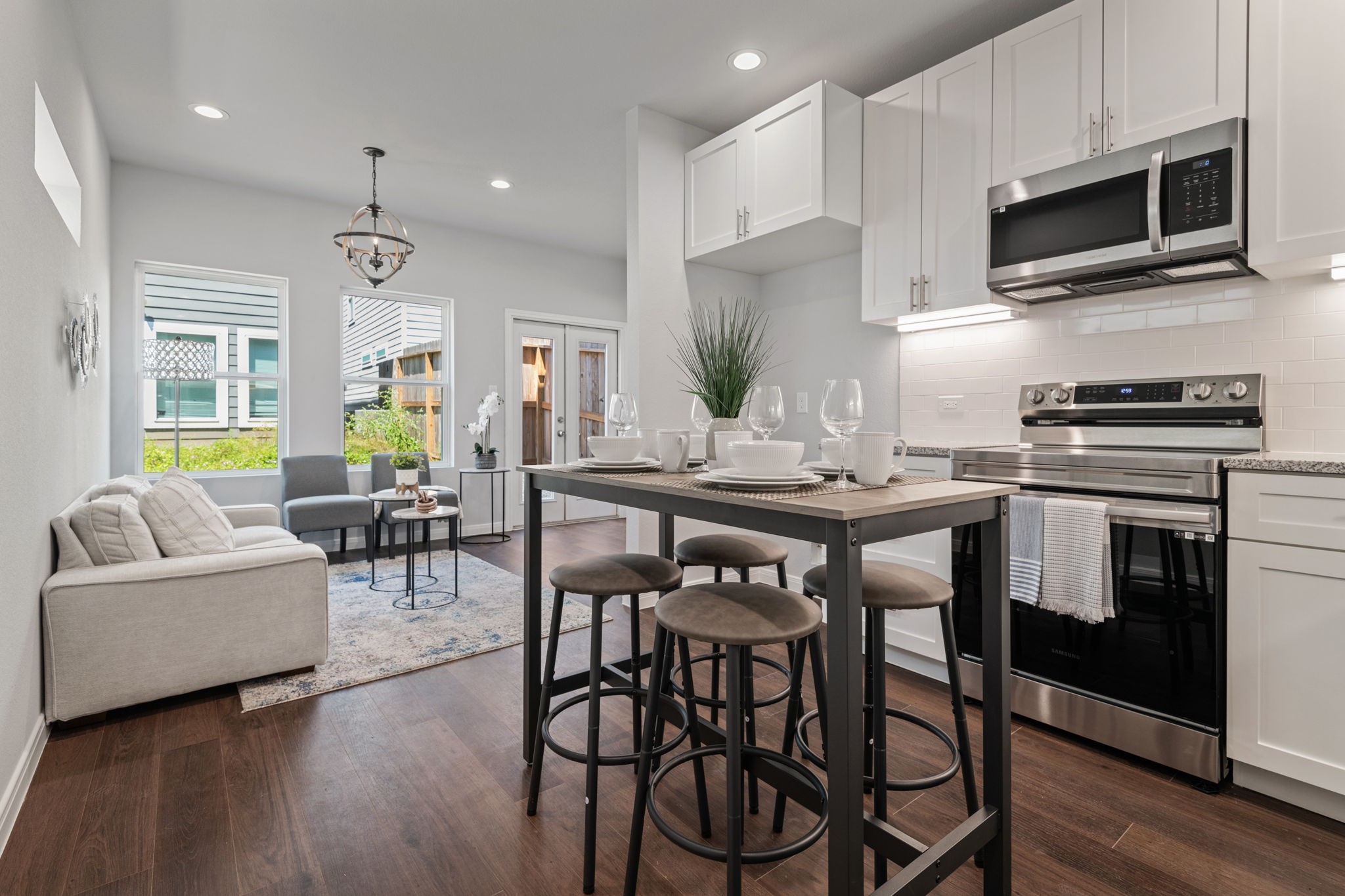 4934 Paradigm Ln Spring Spring, TX 77379 - Photo 6 of 14 a kitchen with stainless steel appliances granite countertop a stove a sink dishwasher a microwave oven and a dining table with wooden floor