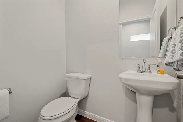 a white toilet sitting next to a bathroom sink