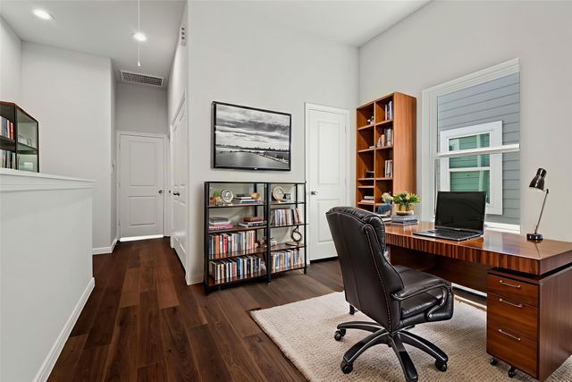 a view of a workspace with furniture and a window