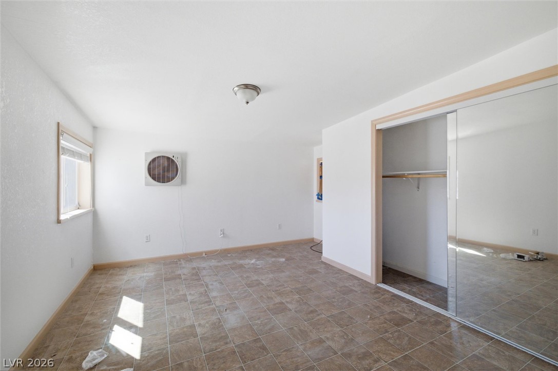 405 Main Street Beatty, NV 89003 - Photo 12 of 28 A versatile room featuring a mirrored closet and durable tile flooring, ready for personalization.
