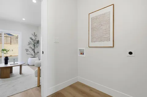 a view of hallway with paintings on the wall