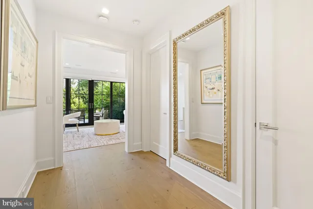 a dining room with wooden floor windows and outdoor view