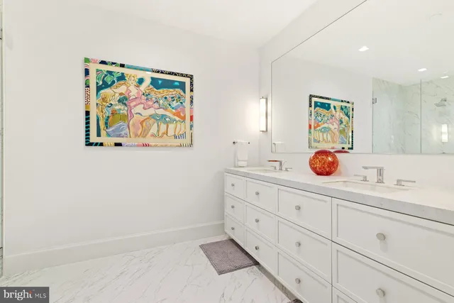 an aerial view of a city with lots of residential buildings ocean and mountain view