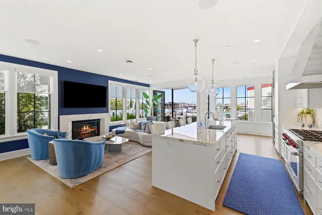 a view of living room with kitchen island furniture and a flat screen tv