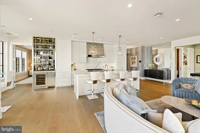 a living room with large windows and furniture