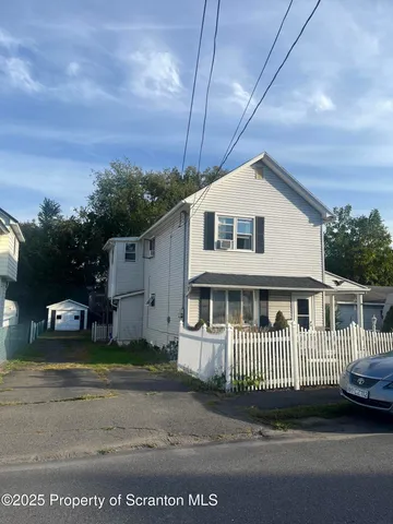 a front view of a house with parking space
