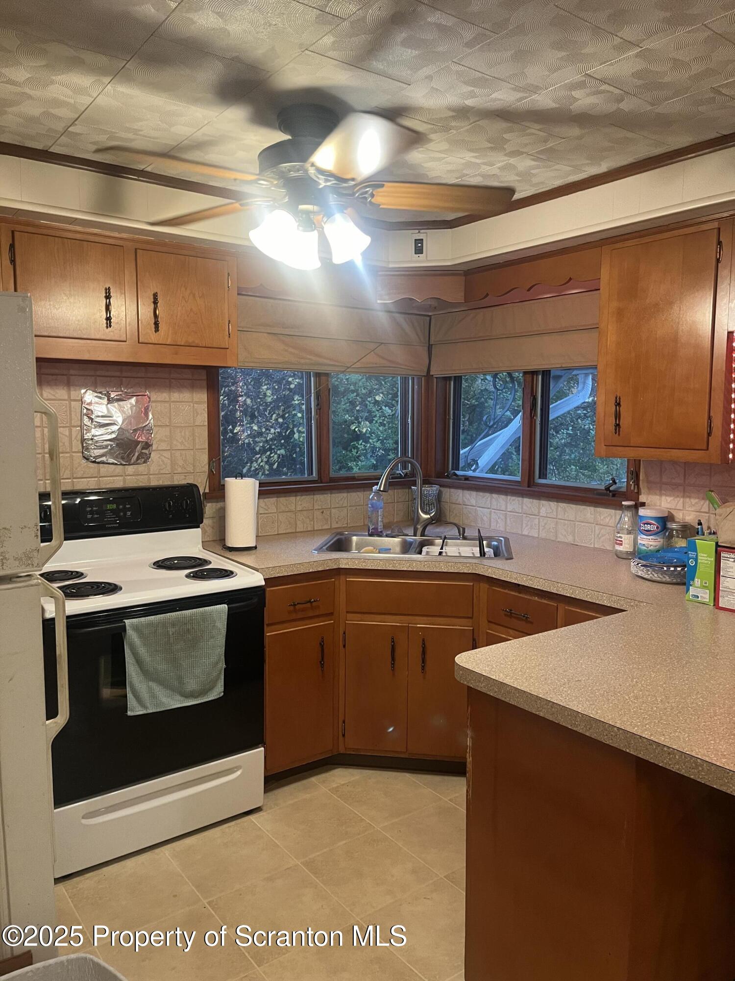 108 3rd Street Blakely, PA 18447 - Photo 8 of 27 a kitchen with stainless steel appliances granite countertop a sink and a stove