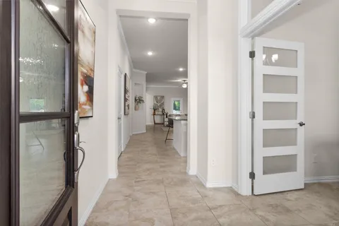 a view of a hallway with wooden floor and staircase