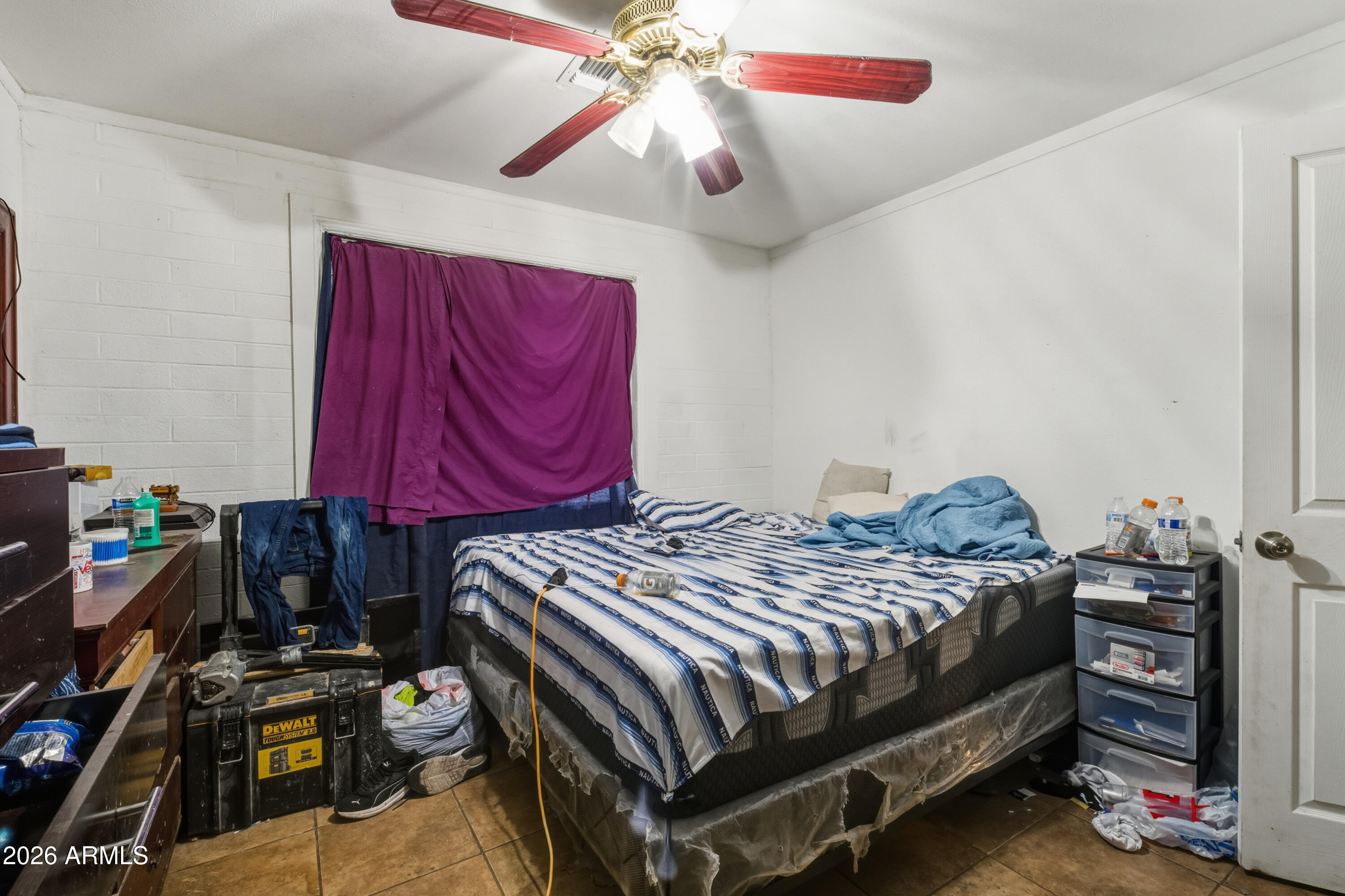 10013 North 16th Avenue Phoenix, AZ 85021 - Photo 12 of 18 a bedroom with a bed and a chandelier