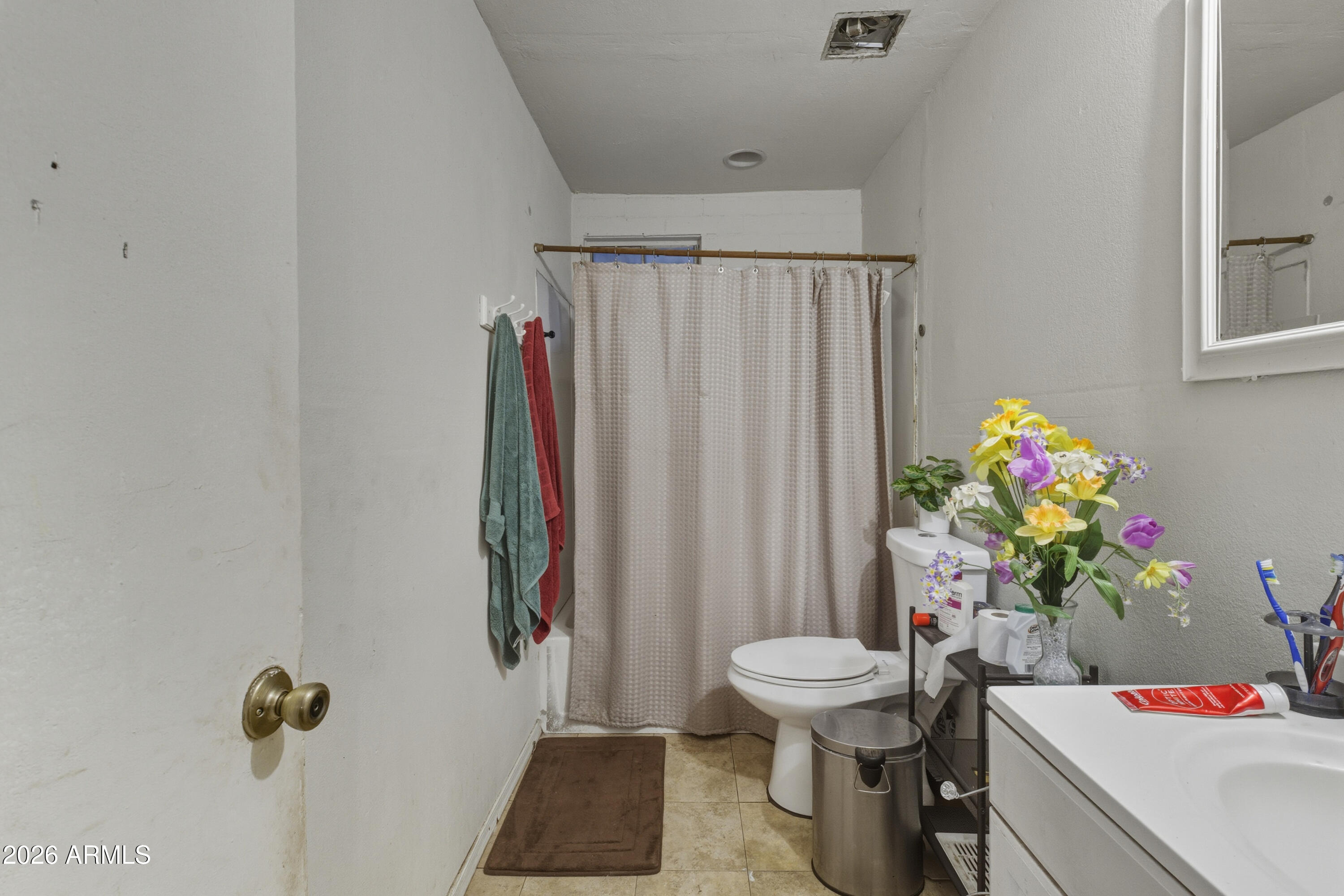 10013 North 16th Avenue Phoenix, AZ 85021 - Photo 13 of 18 a bathroom with a sink toilet and shower curtain