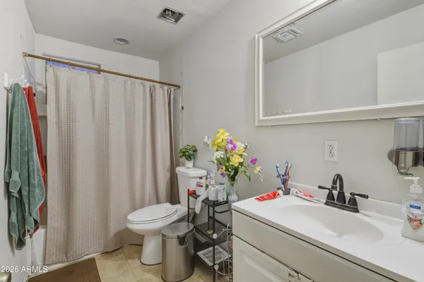 a bathroom with a sink toilet and a mirror