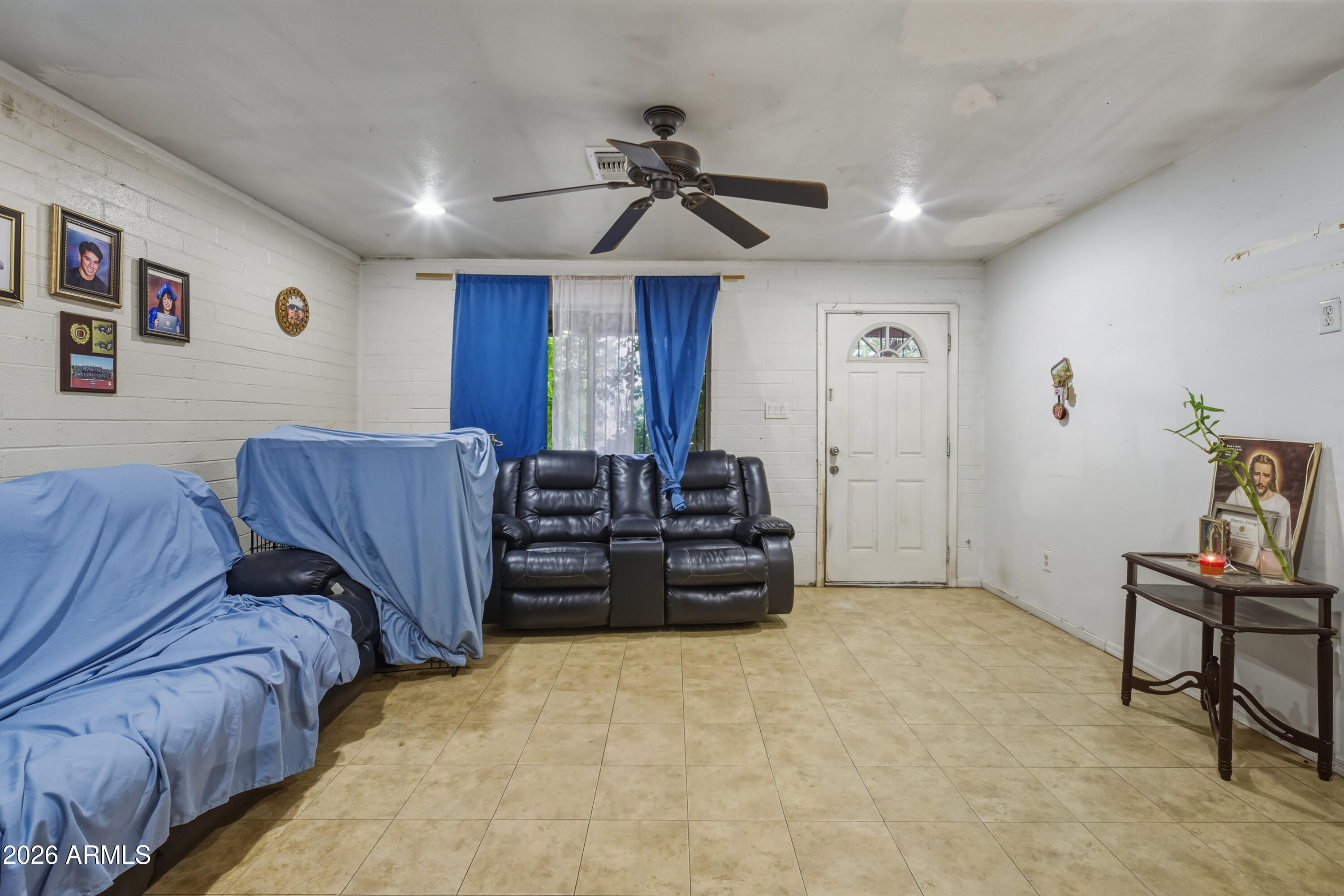 10013 North 16th Avenue Phoenix, AZ 85021 - Photo 2 of 18 a living room with furniture a ceiling fan and a rug