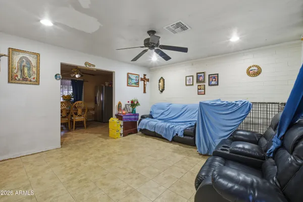 a bedroom with furniture and a ceiling fan
