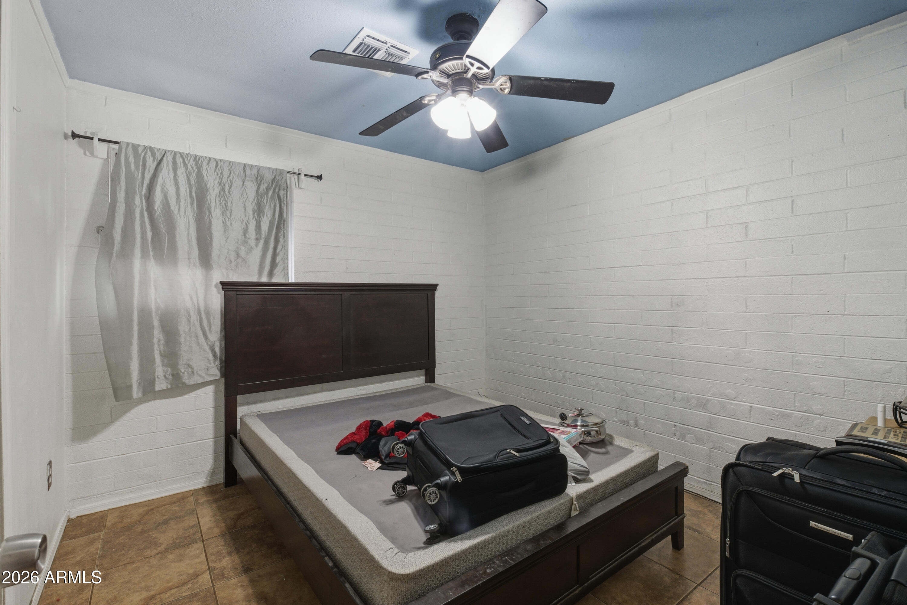 10013 North 16th Avenue Phoenix, AZ 85021 - Photo 9 of 18 a living room with furniture and a flat screen tv