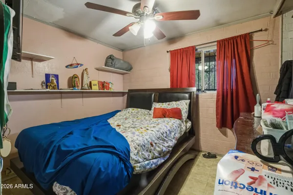 a bedroom with a bed and a dresser