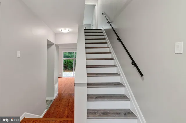 a view of entryway and hall with wooden floor