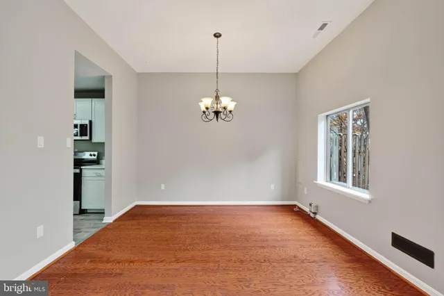 a view of a room with cabinet and wooden floor