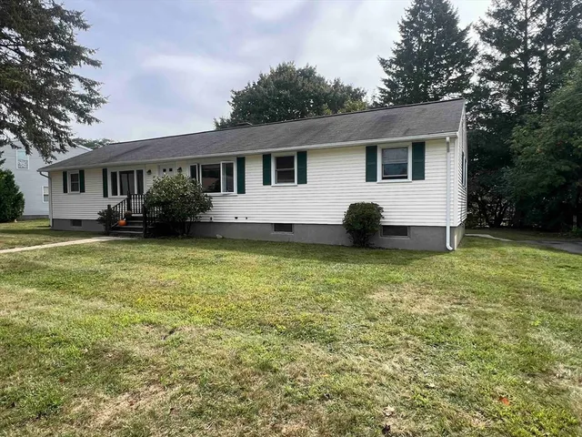 a view of a house with a garden and deck