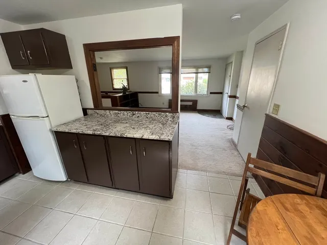 a bathroom with a granite countertop sink a mirror and vanity