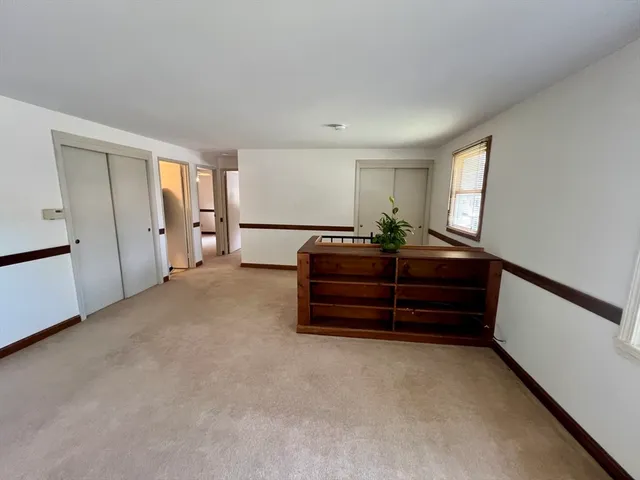 a room with a bed and a window