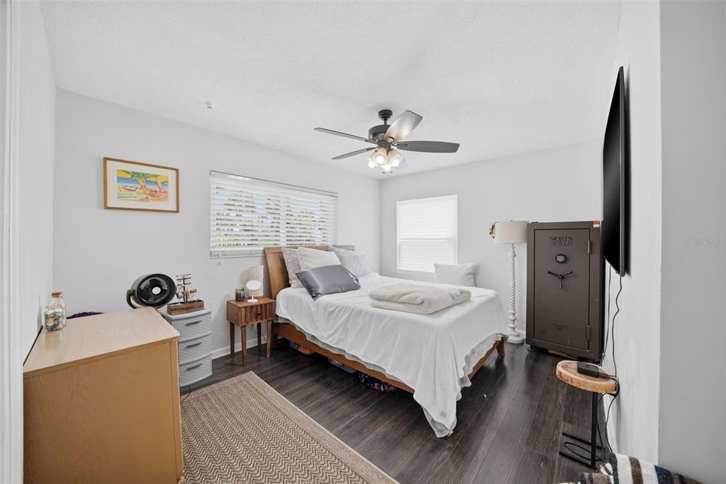 15823 Redington Drive Redington Beach, FL 33708 - Photo 11 of 39 a bedroom with a bed and a chandelier