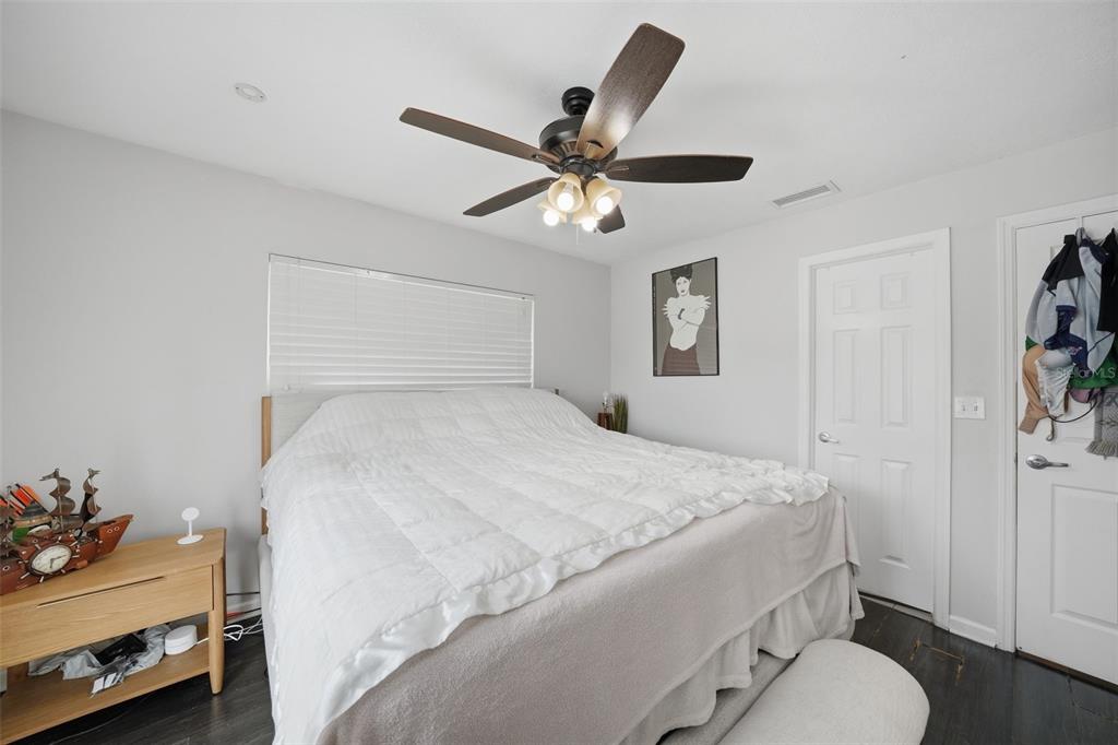 15823 Redington Drive Redington Beach, FL 33708 - Photo 14 of 39 a bedroom with a bed and a chandelier